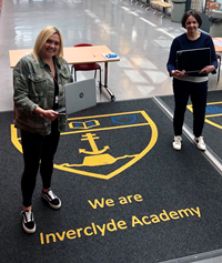 A new joint-initiative involving Inverclyde Council, Inverclyde HSCP and Belville Community Garden Trust has been launched to provide laptops to disadvantaged school pupils to help with their home learning during lockdown. Pictured at Inverclyde Academy, one of the schools to benefit from the scheme, is depute head teacher Susan Chambers, left, and Laura Reilly, from Belville.